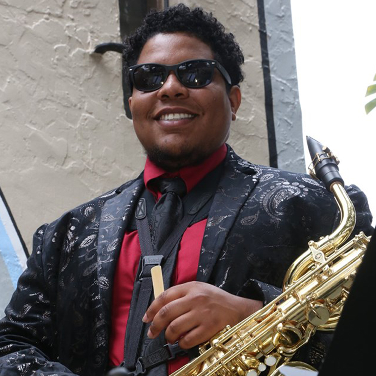 Tyler Johnson has a fun, soulful presence. His baritone sax low end is essential to the music style of The Convertibles.